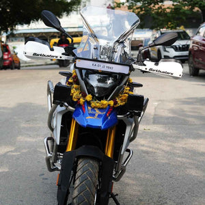 Motodrift Barkbusters VPS white plastic handguards installed on an adventure motorcycle with gold forks