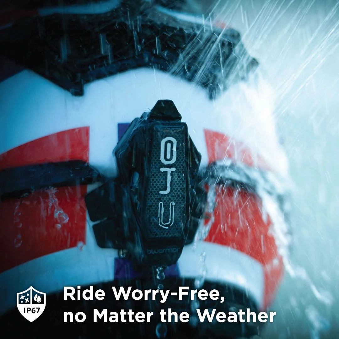 Motodrift BluArmor C40 Bluetooth mesh intercom mounted on a motorcycle helmet during heavy rain, showing IP67 rating.