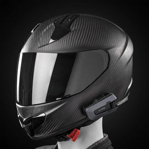 Motodrift Cardo Packtalk Edge motorcycle communication system mounted on a black carbon fiber full-face helmet