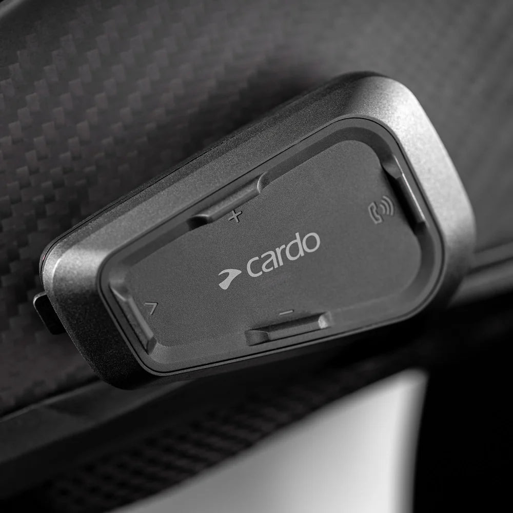 Motodrift Cardo Spirit HD Bluetooth motorcycle intercom unit mounted on a black helmet surface