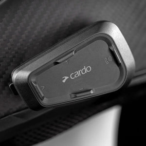 Motodrift Cardo Spirit HD Bluetooth motorcycle intercom unit mounted on a black helmet surface