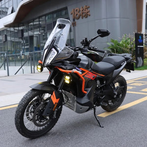 Motodrift Future Eyes Z4 auxiliary LED lights mounted on an adventure motorcycle, providing bright yellow illumination.