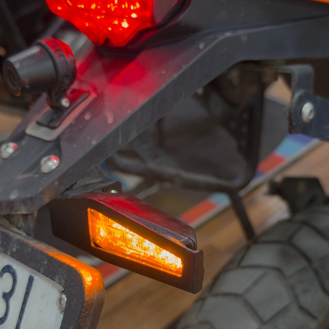 Motodrift LBC Moto indicator guard installed on a KTM motorcycle, protecting the amber LED turn signal light.