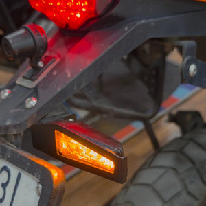 Motodrift LBC Moto indicator guard installed on a KTM motorcycle, protecting the amber LED turn signal light.