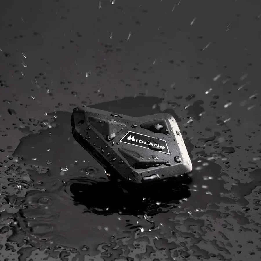 Motodrift MIDLAND BT MINI motorcycle intercom unit in black, shown in rainy conditions to highlight water resistance.