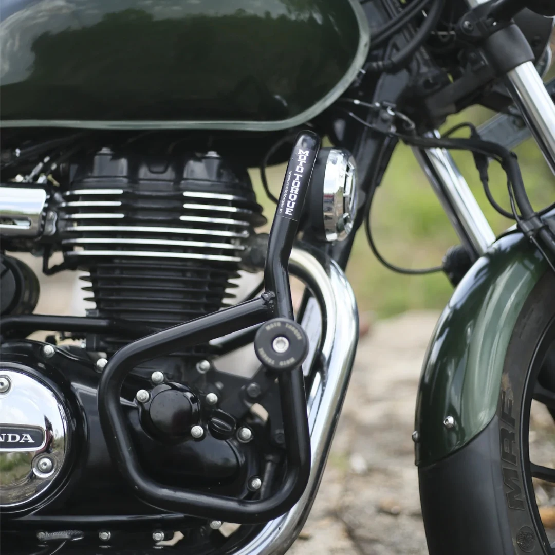Motodrift Moto Torque V2.0 black steel crash guard installed on a green Honda motorcycle engine