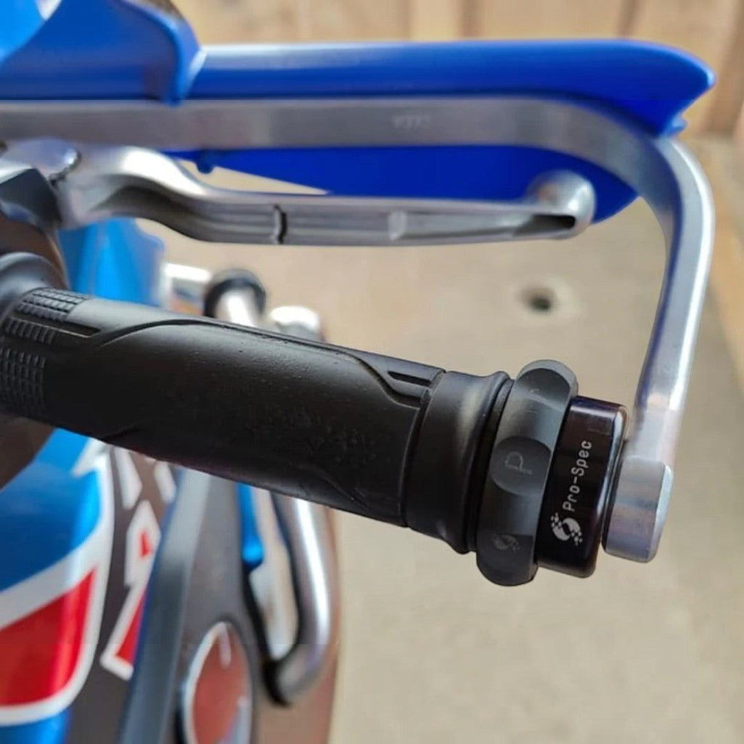 Motodrift Pro-Spec Easy Cruz mechanical throttle lock installed on a motorcycle handlebar with Barkbusters hand guards