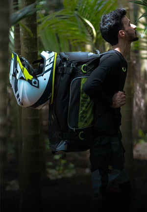 Motodrift Rynox Navigator 50L tail bag worn as a backpack in a forest, featuring Cordura fabric and helmet storage.