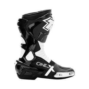 Motodrift TR Tiger X-ONE PRO motorcycle boots in black and white with metal toe sliders and reinforced ankle support.