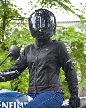 Motodrift ViaTerra Ellis women's black mesh riding jacket with reflective details worn by a rider on a motorcycle