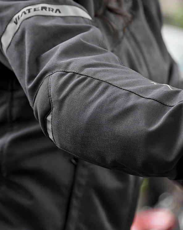 Motodrift ViaTerra Ellis women's black riding jacket featuring reinforced elbow protection and reflective detailing.
