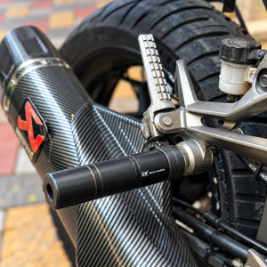 RKTECH exhaust slider installed on a Kawasaki Ninja 300 with carbon fiber muffler and aluminium bracket