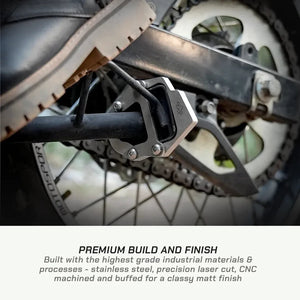 ViaTerra stainless steel side stand shoe installed on a Hero XPulse 210 motorcycle for improved stability.
