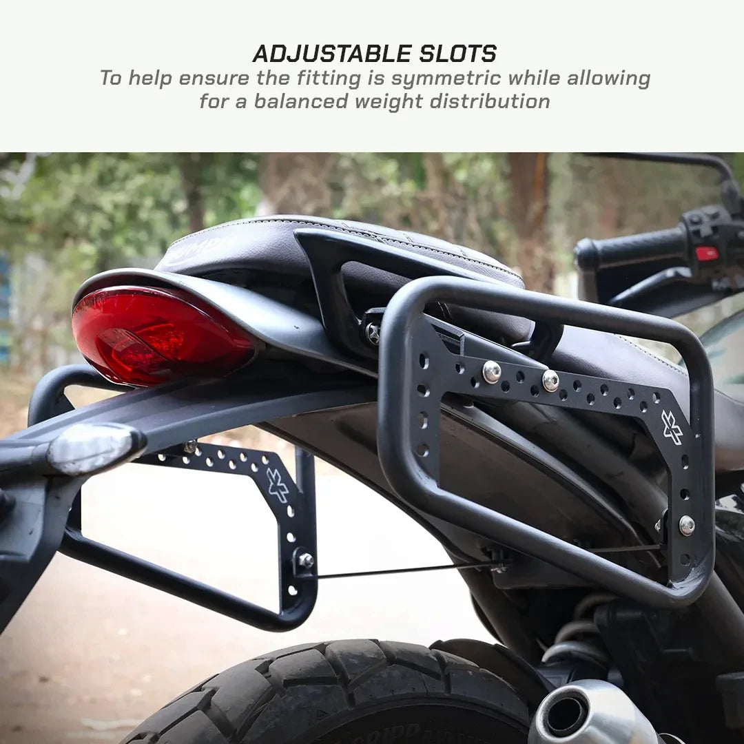 ViaTerra matte black steel saddlebag rack mounted on a Triumph Scrambler 400 X with adjustable slots